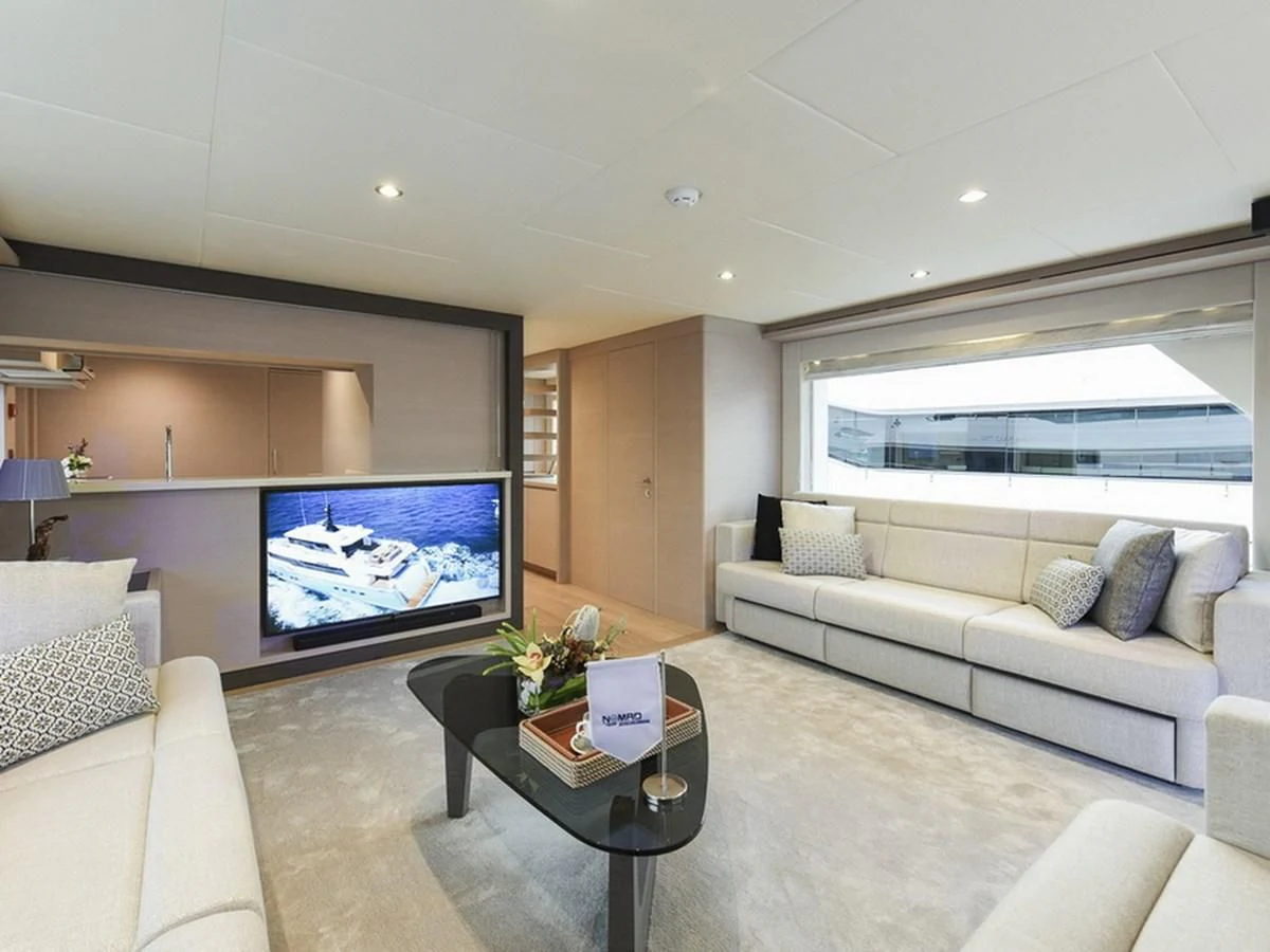 a living room with a large screen aboard NOMAD 70 SUV Yacht for Sale