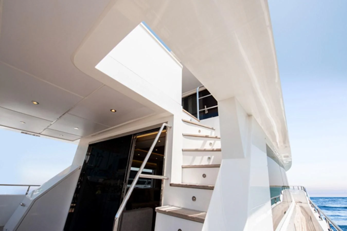 a white building with a white staircase aboard NOMAD 70 SUV Yacht for Sale