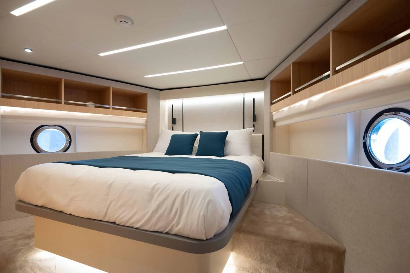 a room with a bed and a window aboard NOMAD 70 SUV Yacht for Sale