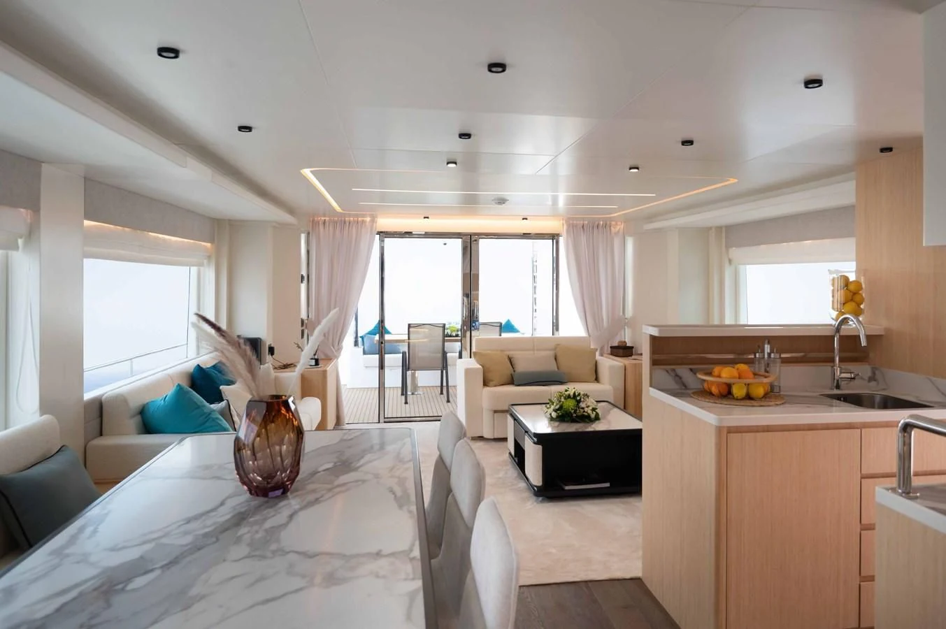 a large kitchen with a large window aboard NOMAD 70 SUV Yacht for Sale