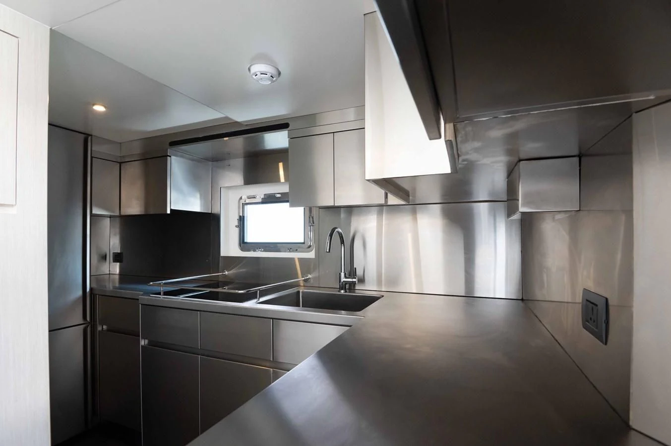 a kitchen with a sink and a microwave aboard NOMAD 70 SUV Yacht for Sale