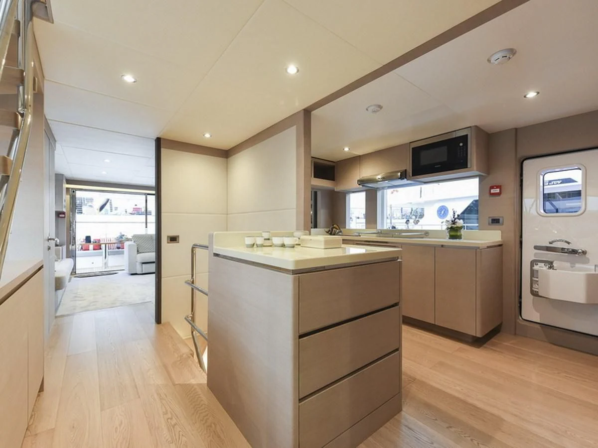 a kitchen with a large window aboard NOMAD 70 SUV Yacht for Sale