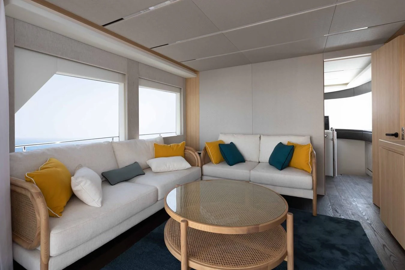 a living room with a couch and a table aboard NOMAD 70 SUV Yacht for Sale