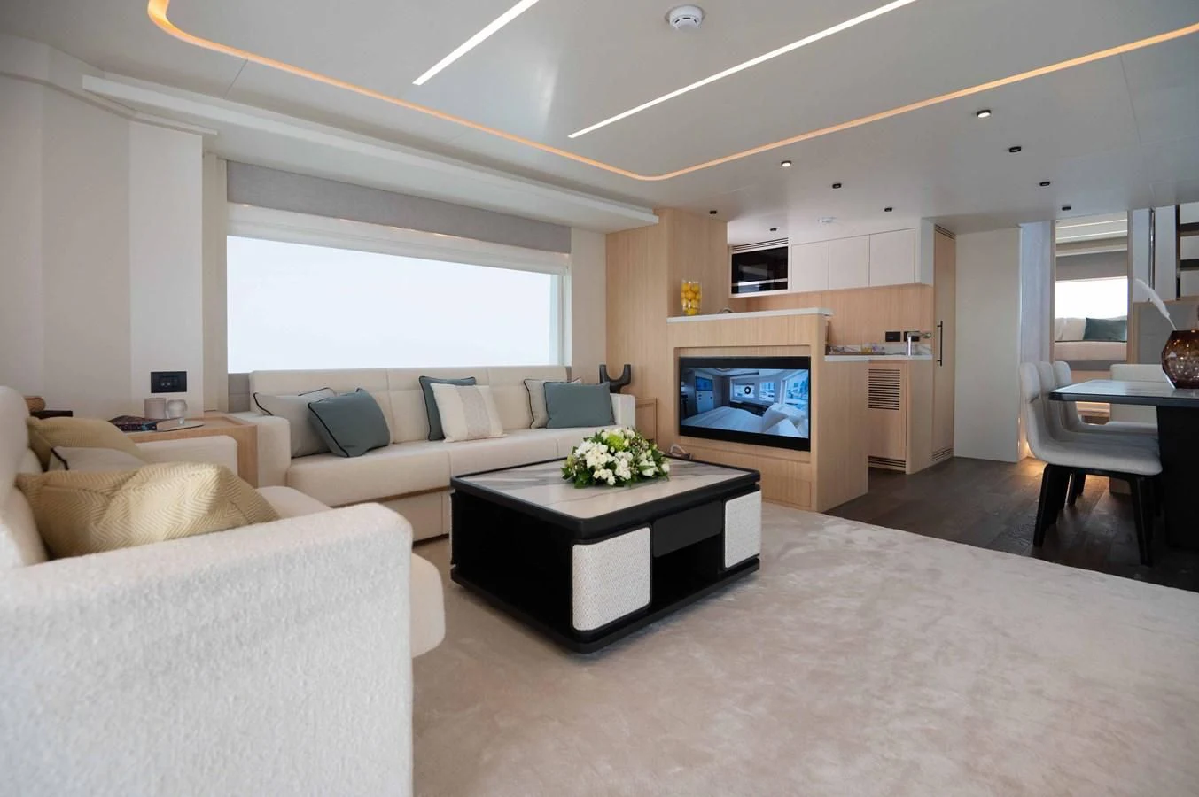 a living room with a fireplace aboard NOMAD 70 SUV Yacht for Sale