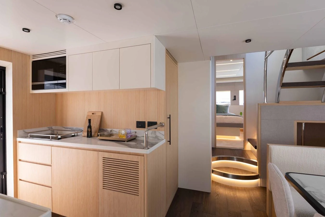 a kitchen with white cabinets aboard NOMAD 70 SUV Yacht for Sale