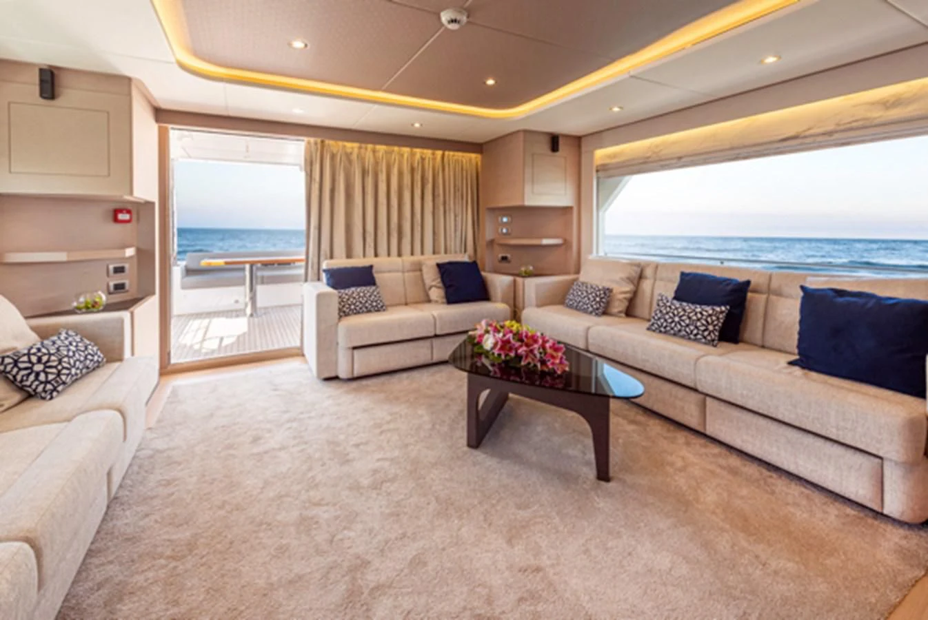 a living room with a couch and a table aboard NOMAD 70 SUV Yacht for Sale