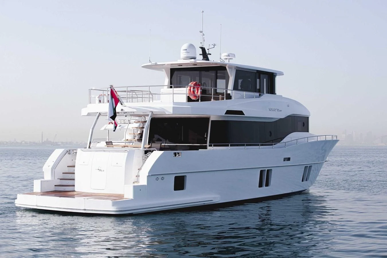 a large white boat in the water aboard NOMAD 70 SUV Yacht for Sale