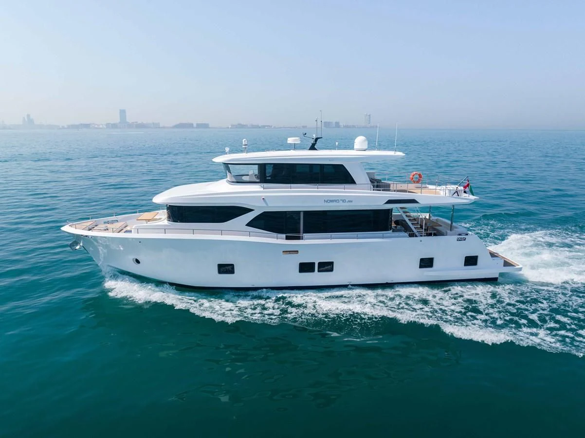 a white yacht in the water aboard NOMAD 70 SUV Yacht for Sale