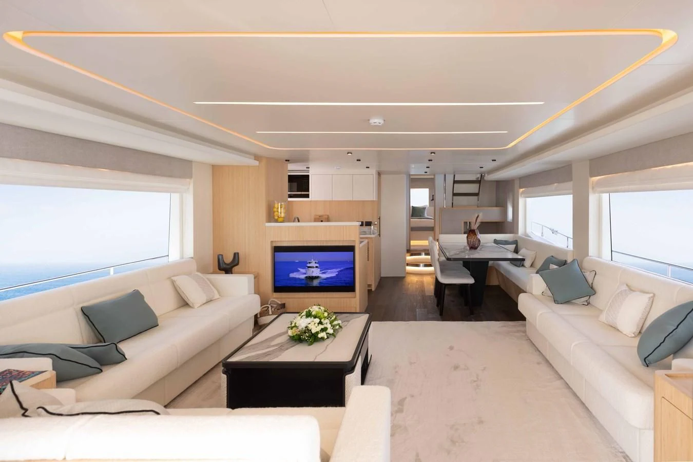 a living room with a large screen aboard NOMAD 70 SUV Yacht for Sale