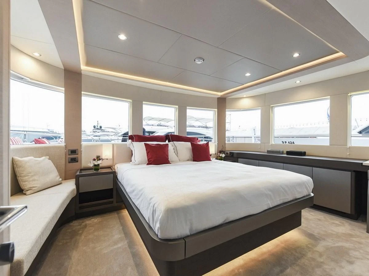 a room with a bed and a window aboard NOMAD 70 SUV Yacht for Sale