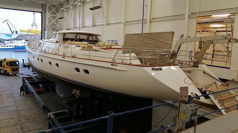 a large white boat in a warehouse aboard JULIET Yacht for Sale
