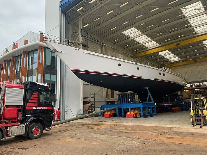 a large warehouse with a red and white container aboard JULIET Yacht for Sale