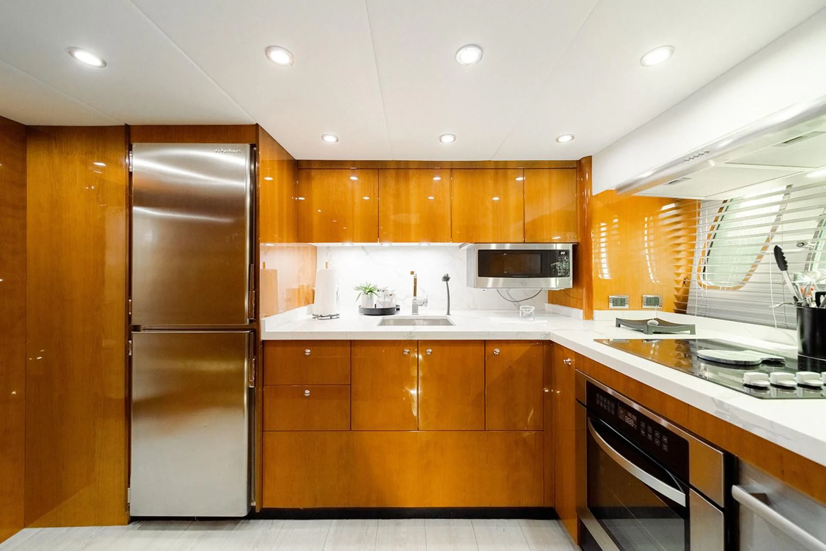 a kitchen with wooden cabinets aboard SOUL MATES Yacht for Sale