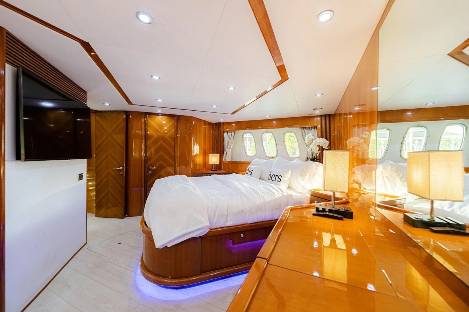 a bedroom with a bed and a desk aboard SOUL MATES Yacht for Sale