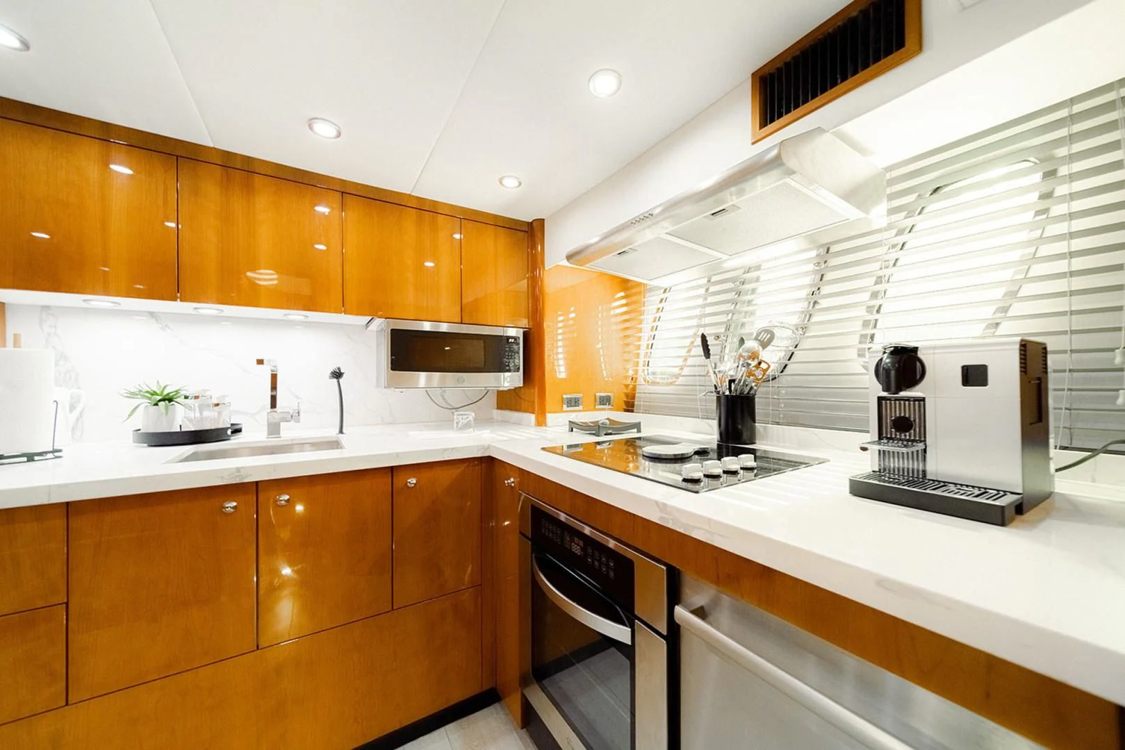 a kitchen with wooden cabinets aboard SOUL MATES Yacht for Sale