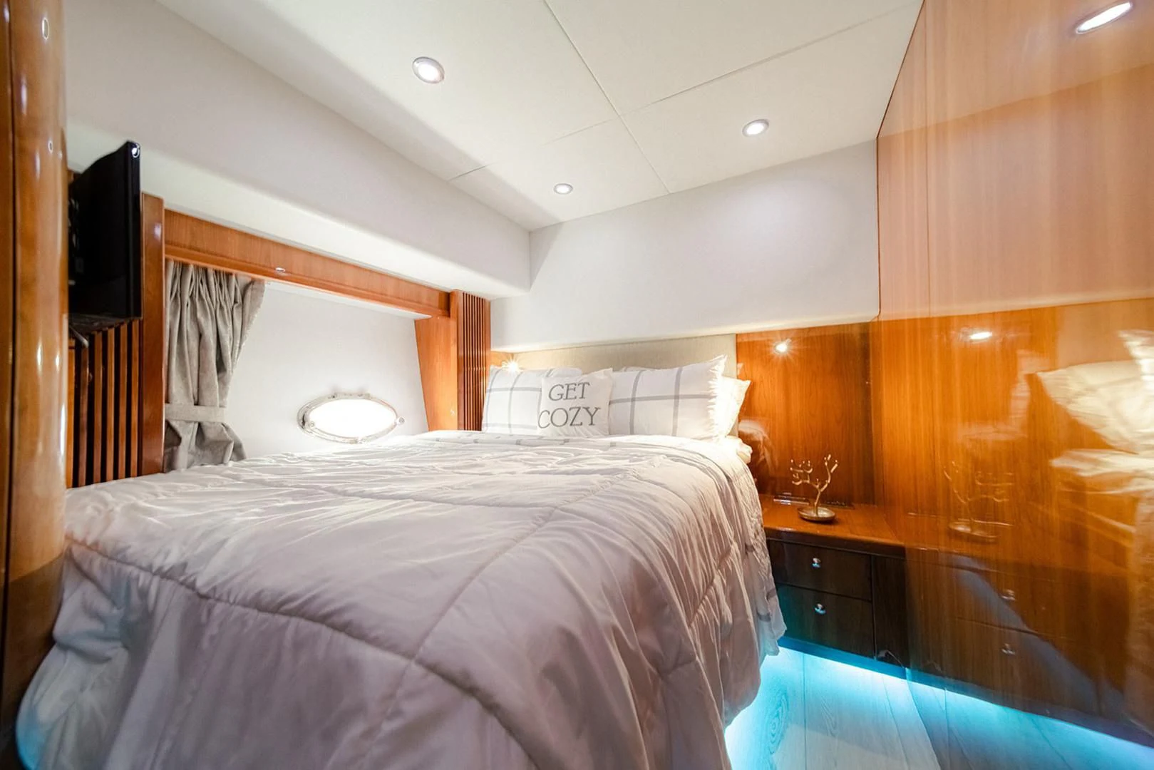 a bedroom with a bed and a television aboard SOUL MATES Yacht for Sale