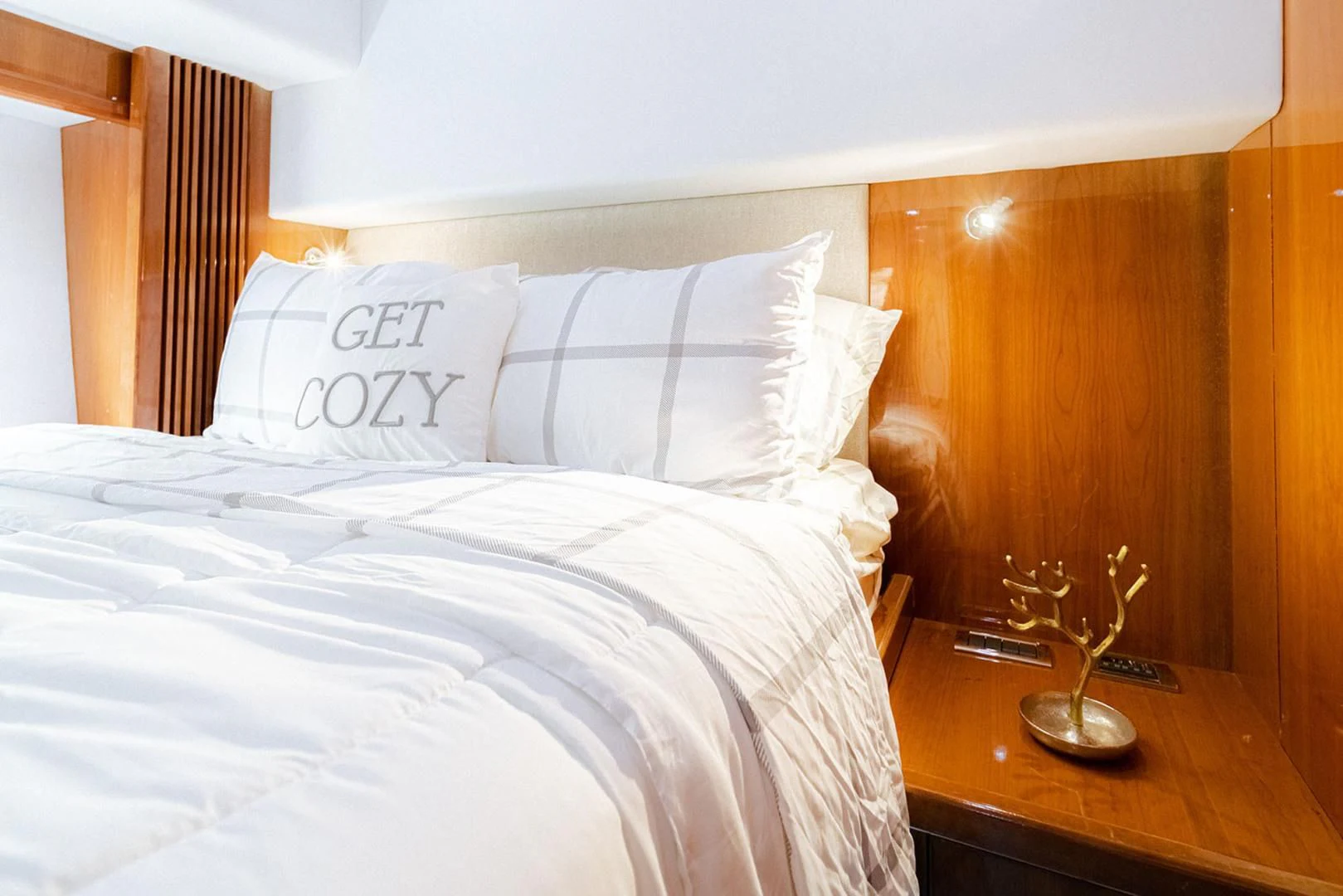 a bed with white sheets and pillows aboard SOUL MATES Yacht for Sale