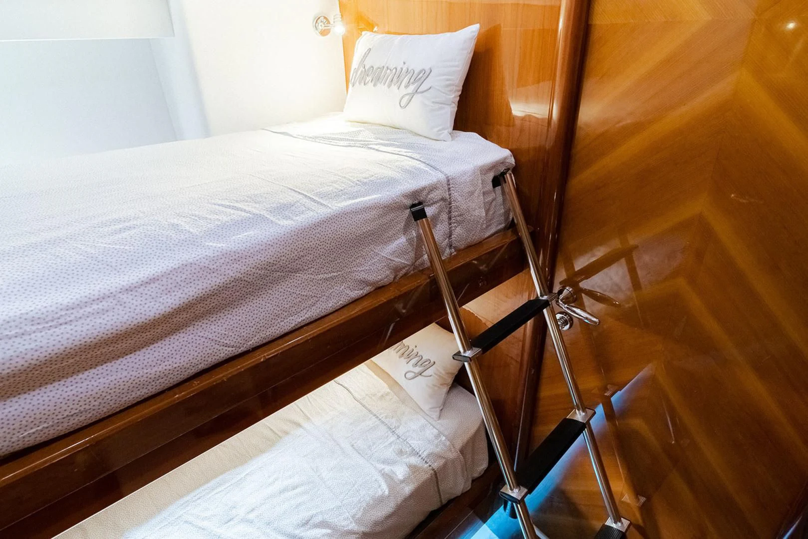a bed with a white sheet and a ladder aboard SOUL MATES Yacht for Sale