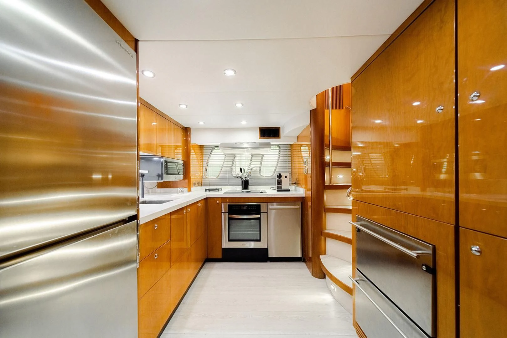 a kitchen with wooden cabinets aboard SOUL MATES Yacht for Sale