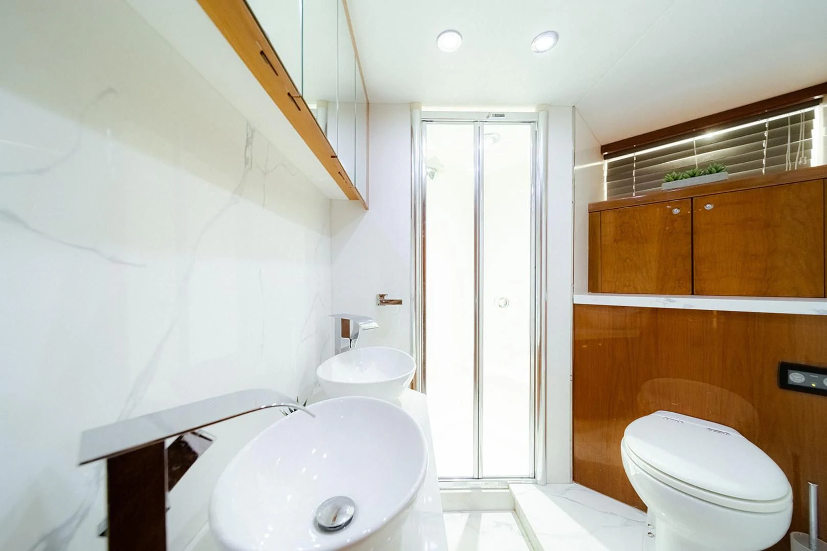 a bathroom with a sink toilet and a shower unit aboard SOUL MATES Yacht for Sale