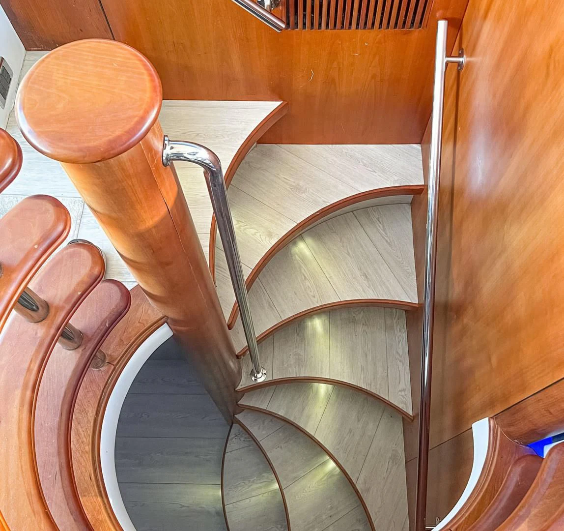 a wooden chair with a metal frame aboard SOUL MATES Yacht for Sale