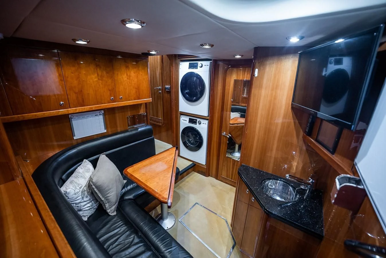 a living room with a leather couch aboard DELFINO Yacht for Sale