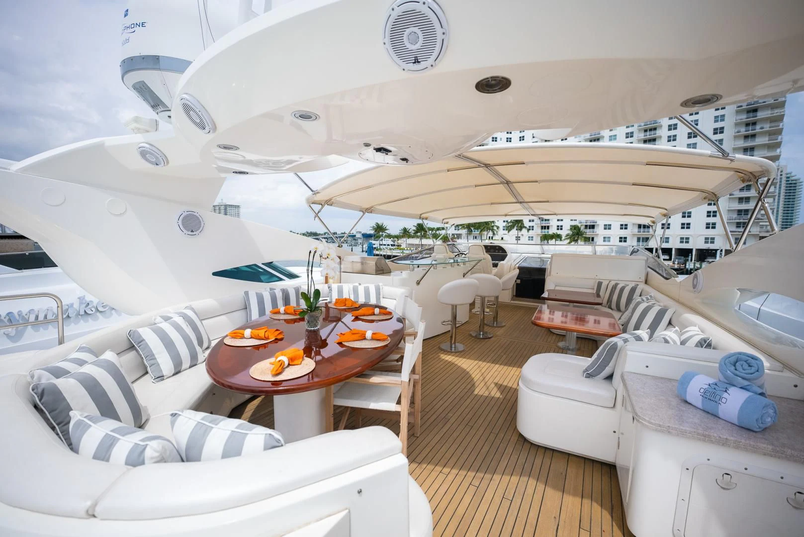 a room with a large bed and a table with chairs aboard DELFINO Yacht for Sale