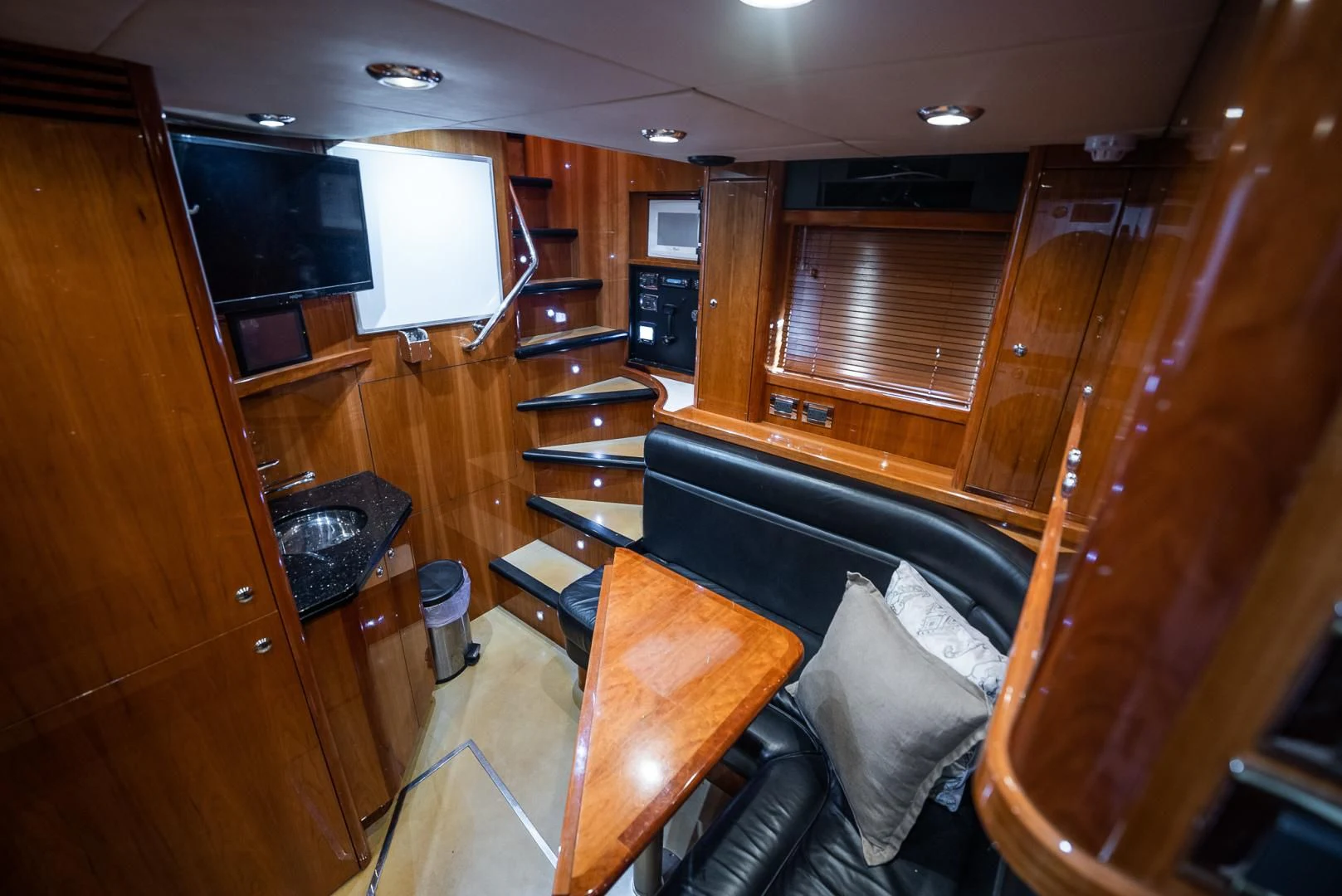 a living room with wood furniture aboard DELFINO Yacht for Sale