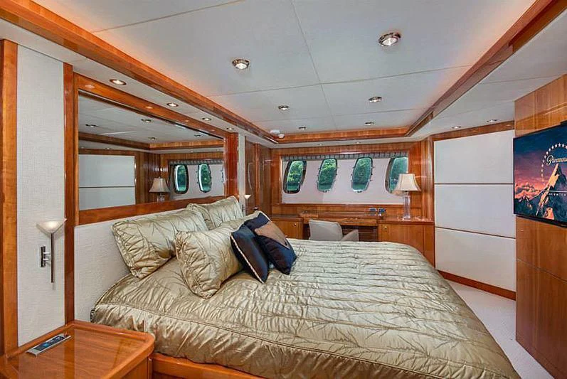 a bedroom with a bed and a mirror aboard DELFINO Yacht for Sale