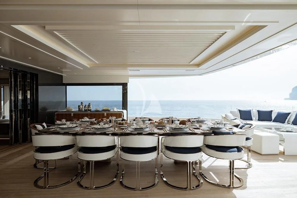 a room with many chairs and a large screen aboard LASATA Yacht for Sale