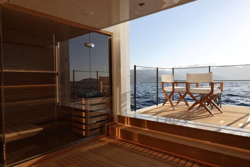 a room with a bed and a table and chairs aboard LASATA Yacht for Sale