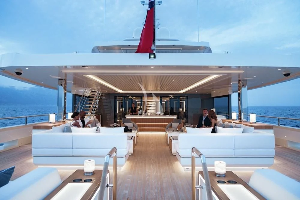 a boat with a deck and a couple of people sitting on it aboard LASATA Yacht for Sale