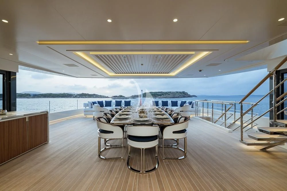 a room with a table and chairs aboard LASATA Yacht for Sale