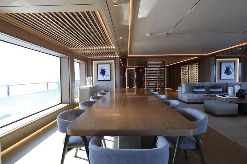 a large living room with a large table and chairs aboard LASATA Yacht for Sale