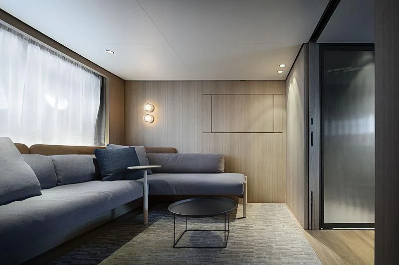 a living room with a couch and a coffee table aboard NOW Yacht for Sale