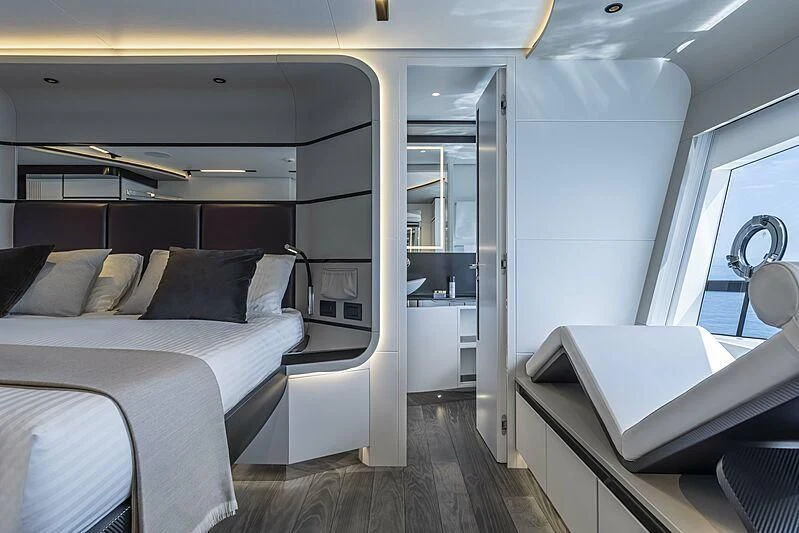 a room with a bed and a desk aboard ALDABRA Yacht for Sale