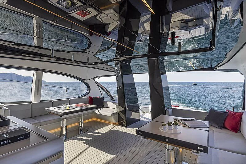 a room with a table and a couch and a window aboard ALDABRA Yacht for Sale