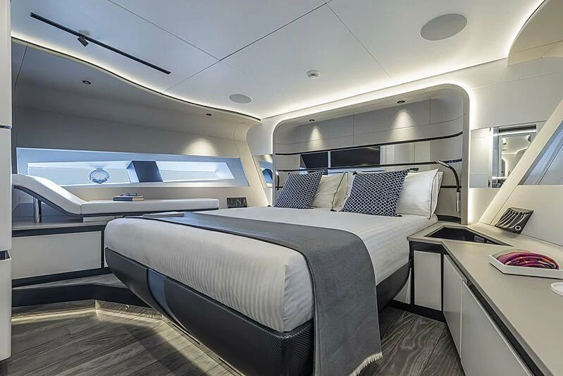a room with a bed and a desk aboard ALDABRA Yacht for Sale
