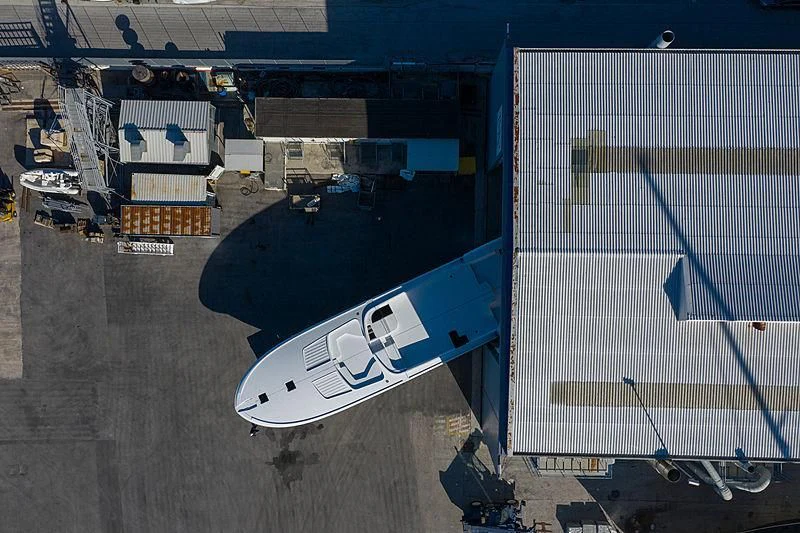 a white surfboard in a warehouse aboard ALDABRA Yacht for Sale