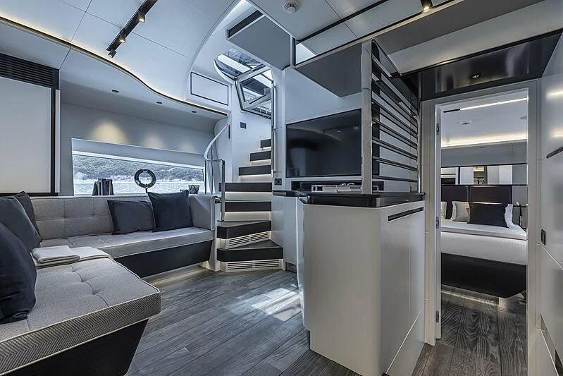 a room with a couch and a staircase aboard ALDABRA Yacht for Sale