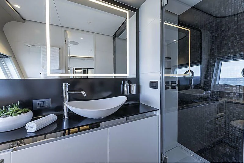 a modern bathroom with a large mirror aboard ALDABRA Yacht for Sale