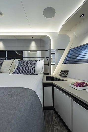 a room with a bed and a desk aboard ALDABRA Yacht for Sale
