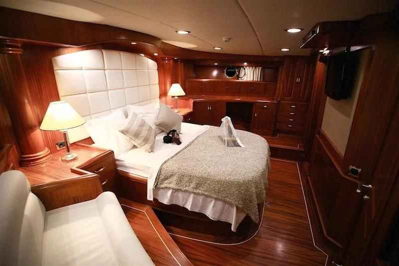 a bedroom with a bed and a desk aboard NURTEN A Yacht for Sale