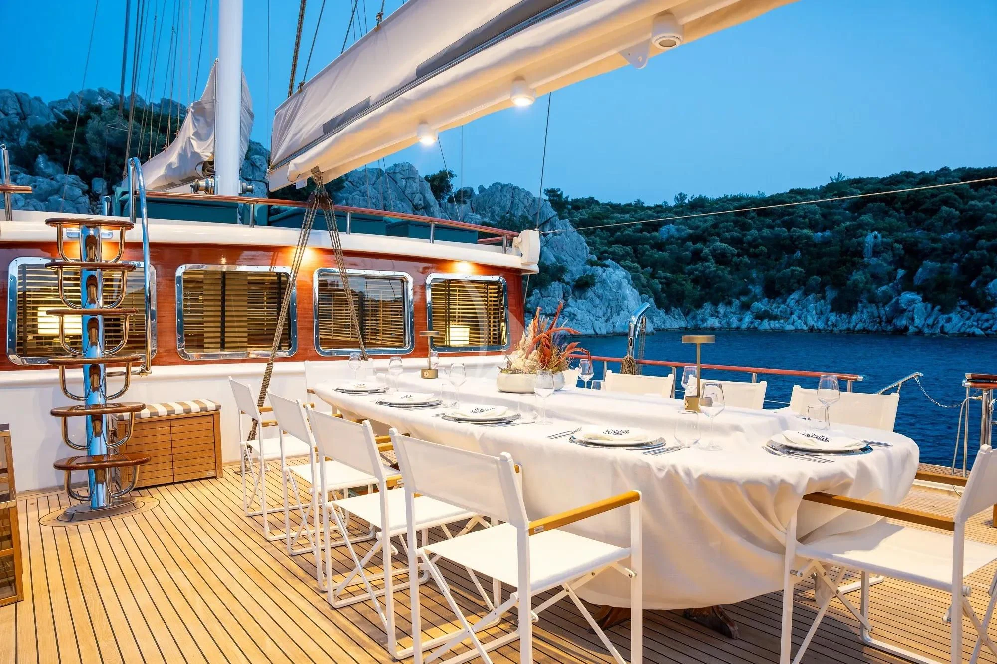 a table and chairs on a deck overlooking a body of water aboard NURTEN A Yacht for Sale