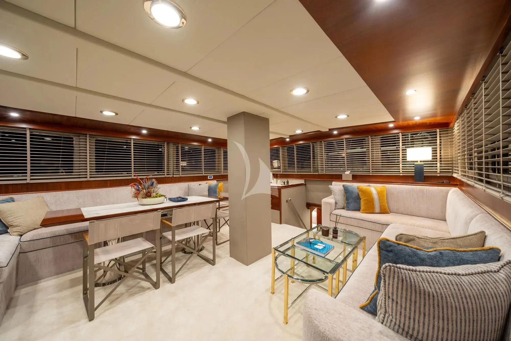 a large room with a table and couches aboard NURTEN A Yacht for Sale