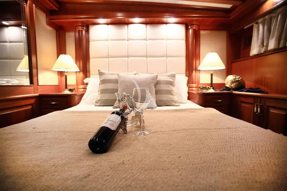 a bottle of champagne on a bed aboard NURTEN A Yacht for Sale