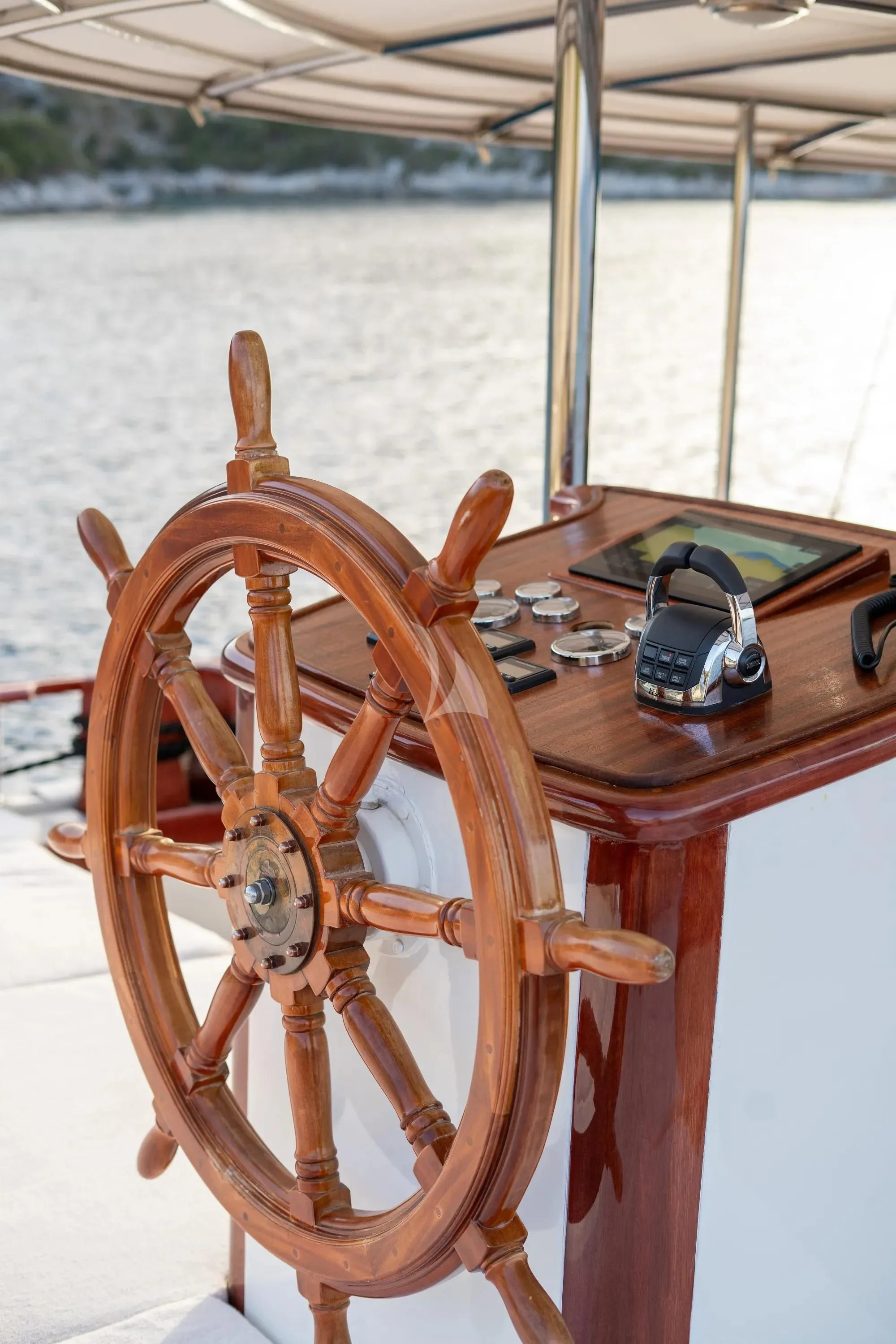 a wooden boat with a steering wheel aboard NURTEN A Yacht for Sale
