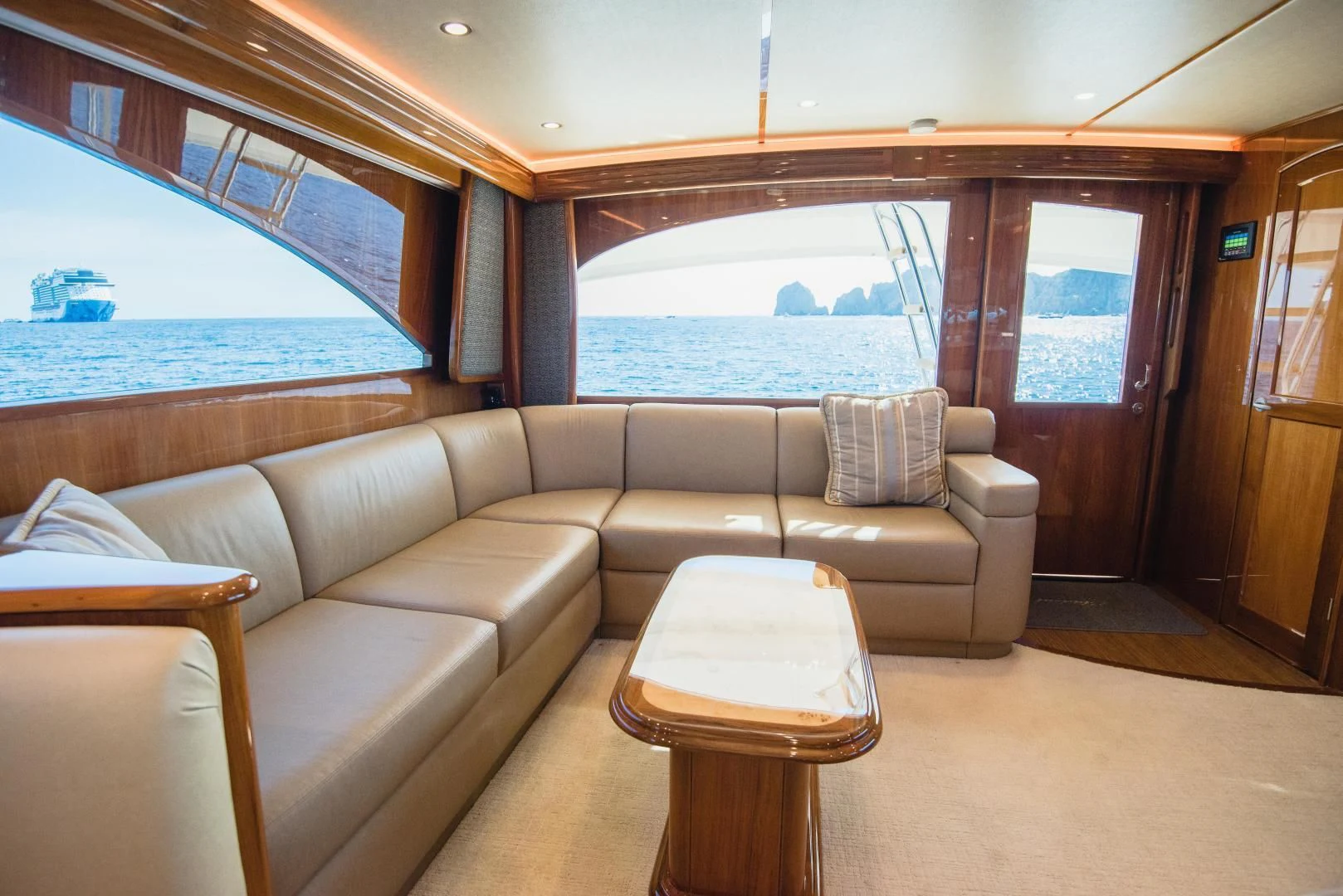 a couch and a table in a room with a view of the water aboard C STUDENT Yacht for Sale