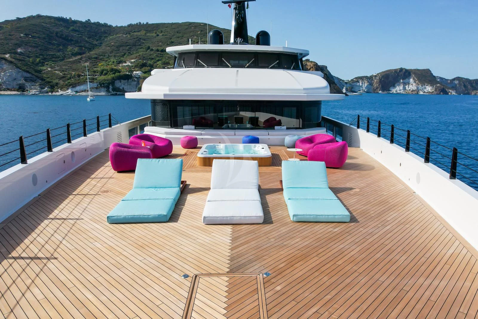 a deck with a pool and a building in the background aboard RIO Yacht for Sale