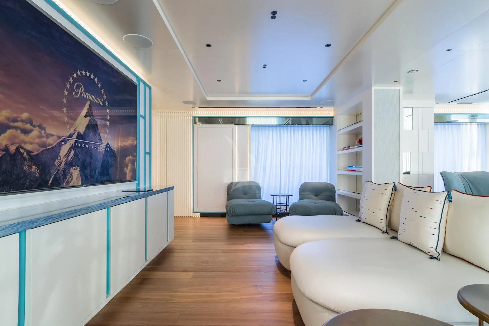 a living room with a blue and white striped wall aboard RIO Yacht for Sale